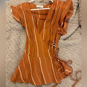 burnt orange striped wrapped blouse